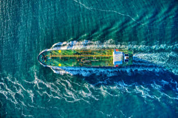 aerial view of white and yellow boat on body of water during daytime
